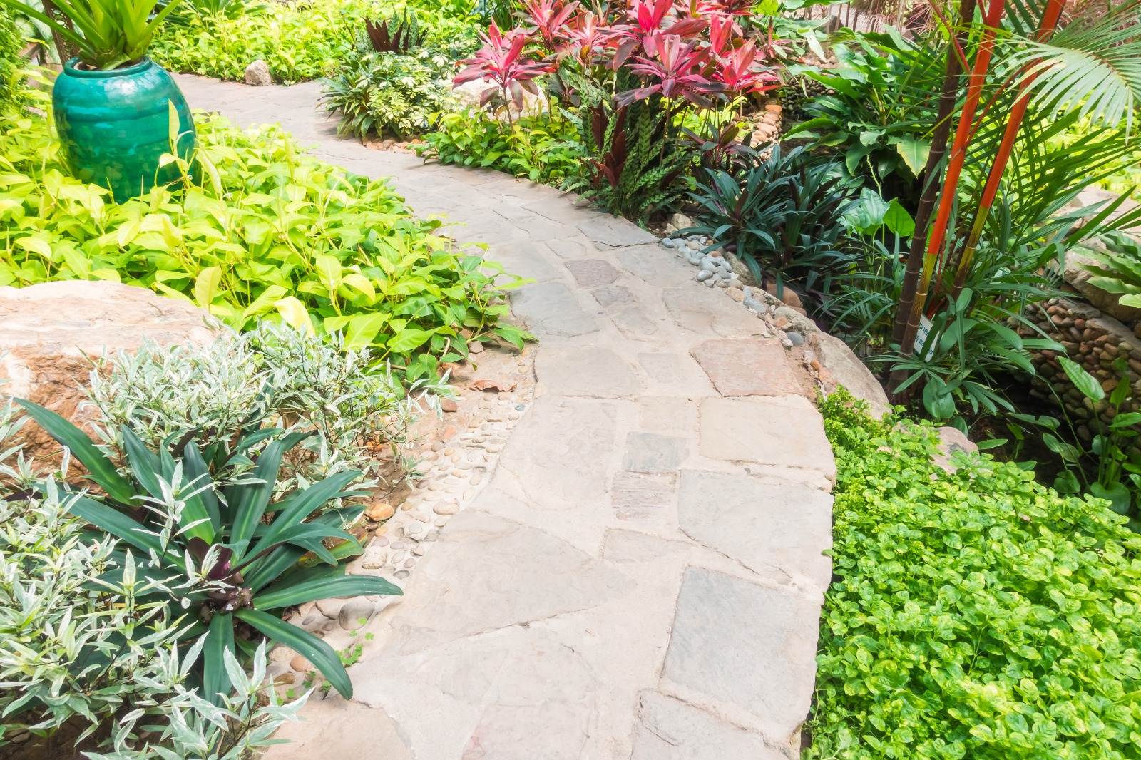 Stone garden path through planted beds