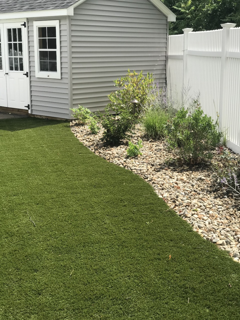 Sod lawn and river-rock planting